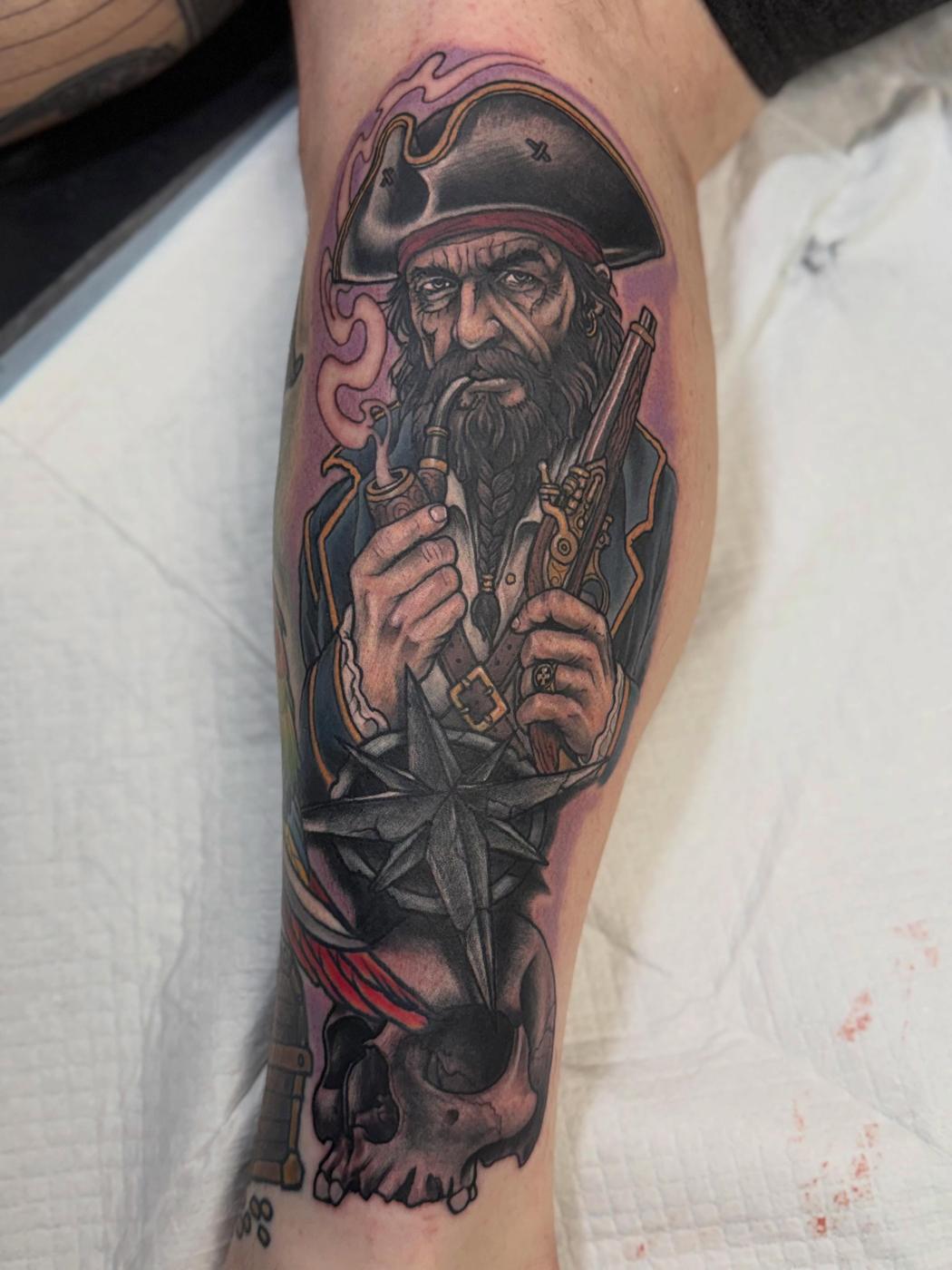 A color pirate sleeve tattoo