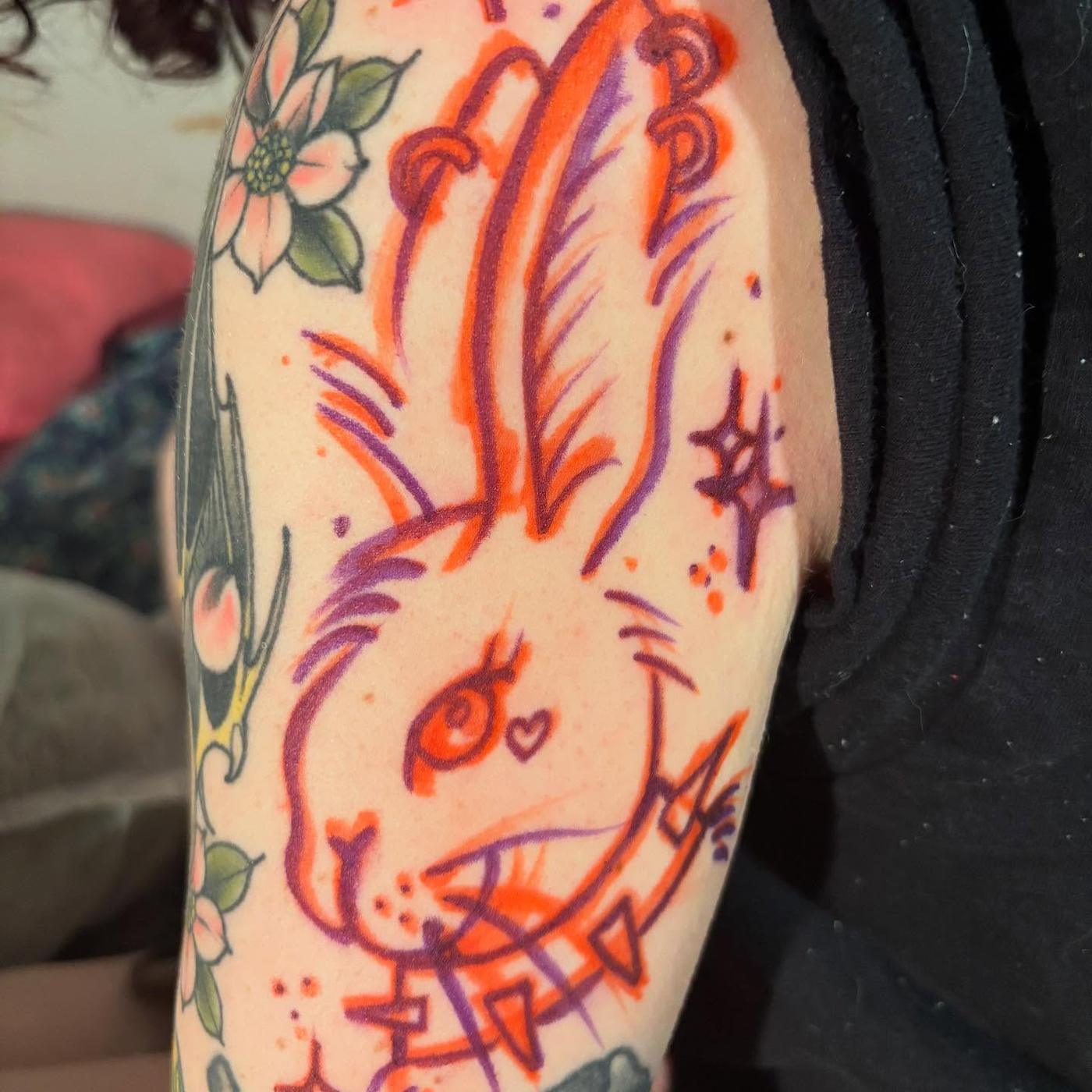 The stencil for a neo-traditional rabbit tattoo drawn on an arm