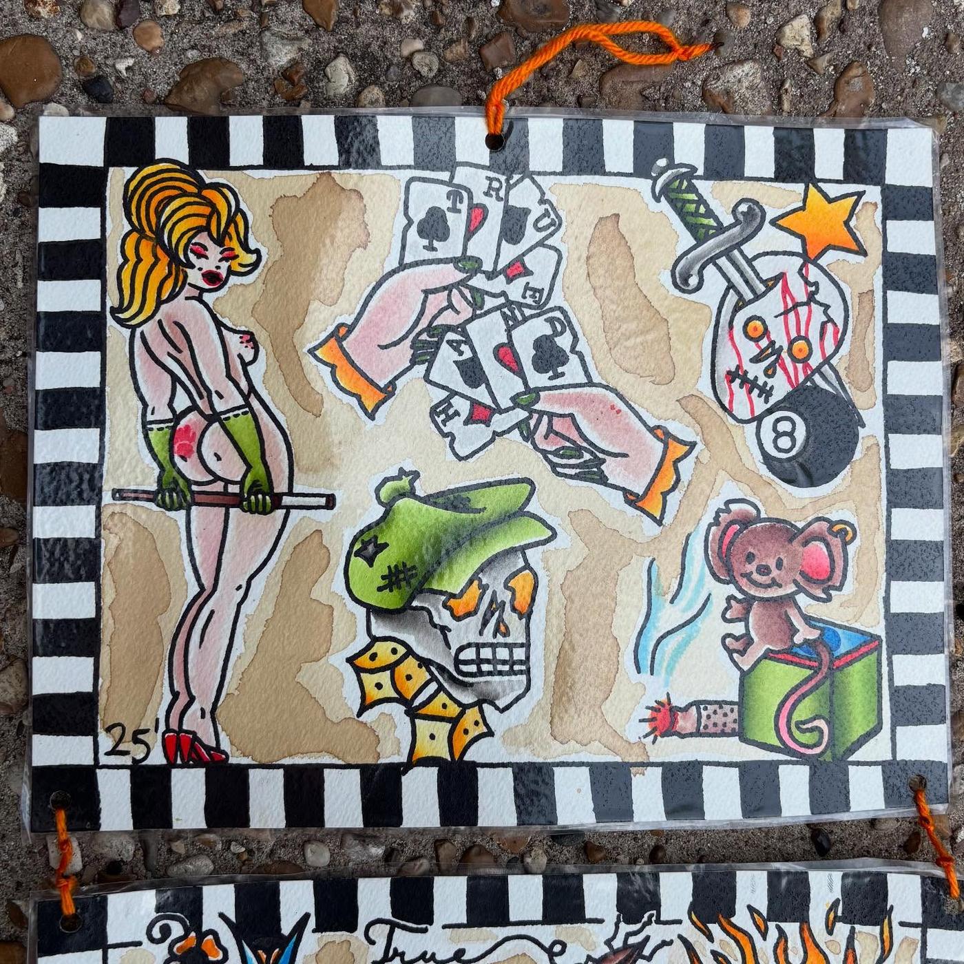A hand-painted flash sheet of traditional tattoo designs