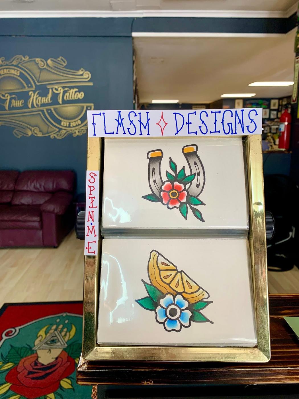A second board of hand-painted flash designs in the shop